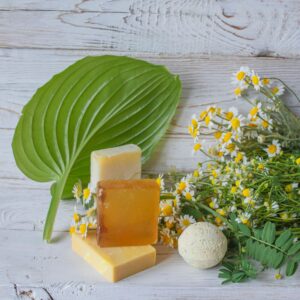 Natural handmade soap with chamomile and bath bomb. Natural handmade soap and chamomile flowers
